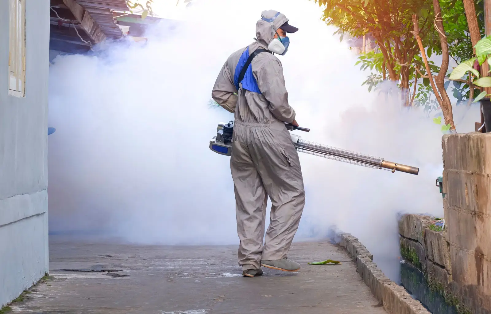 outdoor-healthcare-worker-spraying-chemical-eliminate-mosquitoes-prevent-dengue-fever-slum-scaled.jpg